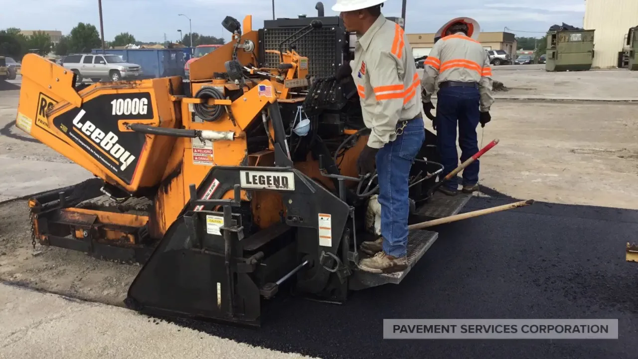 Pavement Services Corporation crew laying fresh asphalt